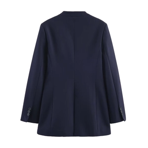 Back view of navy blue collarless blazer with slim-fit tailoring and center vent detail