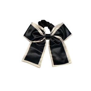 Elegant large black and white satin bow scrunchie for low ponytail hair styling