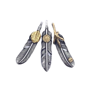 Vintage titanium steel feather pendants with turquoise and gold eagle claw details