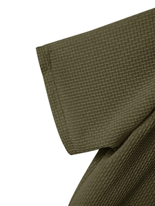 Detail of olive green waffle knit fabric showing texture and stitching on men's sport tee