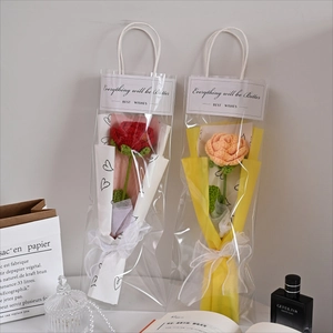Hand-knitted crochet rose bouquet in elegant gift bag with delicate ribbon bows