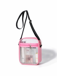 Detailed capacity view of pink clear PVC shoulder bag with makeup items and nylon strap