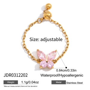 Detail view of adjustable gold butterfly ring with pink zircon and stainless steel chain