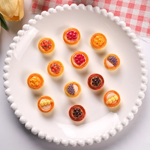 Miniature resin fruit tart set with 12 assorted dollhouse dessert models on a white plate