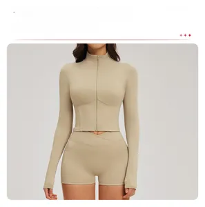 Detail of slim fit yoga jacket with stand collar and zipper in light beige color