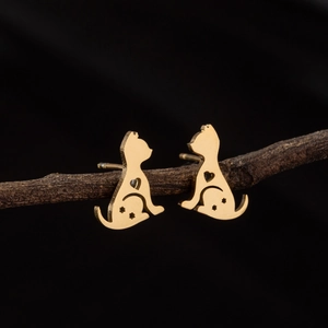 Minimalist gold cat stud earrings with heart cutouts displayed on a natural branch