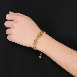 Macro shot of 18K gold plated stainless steel V-shape horseshoe bracelet on wrist
