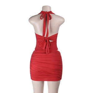 Detail of red backless halter mini dress featuring ruched texture and bodycon fit