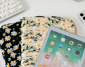 Detail shot of dual metal zippers on embroidered daisy laptop sleeve for iPad storage