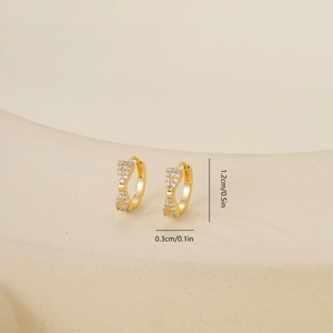 Detailed view of gold bow earrings with zircon stones and 1.2cm size measurements