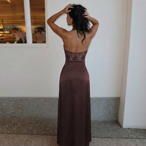 Detail of a brown backless satin dress featuring delicate lace stitching and halter neck