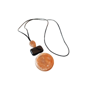 Minimalist coffee brown teardrop necklace with geometric pendants on a black string