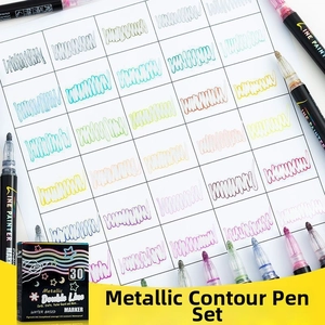 Close-up of 30 colors water-based double line outline markers on grid paper