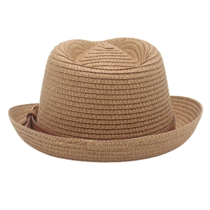Close-up of tight straw weave texture and brown leather decorative band on trilby hat