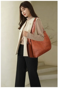 Detail of retro brown tote bag featuring quilted checkered stitching and oil wax texture