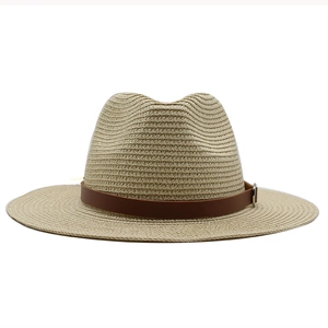 Detail of light beige Panama straw hat showing fine spiral weave and brown leather strap