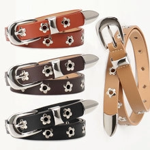 Detailed view of four thin leather belts with flower metal studs in multiple colors