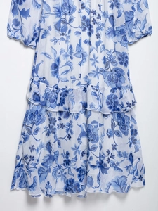 Close-up of blue and white floral chiffon dress detailing ruffle edges and fabric texture