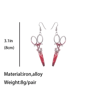 Detail view of bloody scissors earrings with 8cm length and 8g weight specifications
