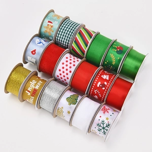 Flat lay of Christmas ribbons with gingerbread and snowflake patterns on white background