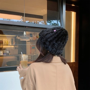Women's warm black faux fur knit beanie hat featuring a stylish purple button decoration
