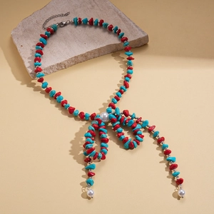 Ethnic bohemian necklace with turquoise stones, red beads and pearl bow design