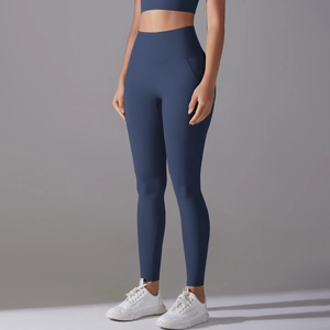 Macro detail of the high-waisted deep blue yoga pants with premium elastic fabric texture