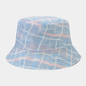 Close-up of a double-sided bucket hat with blue and pink graffiti pattern and stitched brim