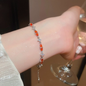 Detail of orange marquise cut zircon bracelet with sparkling crystals on female wrist