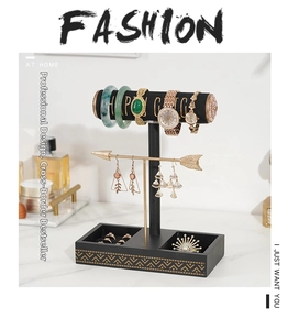 Detail of a T-bar jewelry display stand with watch holders and earring hooks on marble