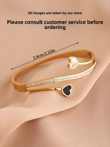 Detail of gold double-layer heart bangle with zircons and shell inlay, 5.9cm diameter