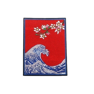 Embroidered iron-on patch featuring ocean waves and cherry blossoms in red and blue