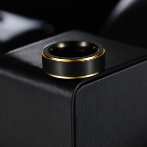 8mm black matte titanium steel ring for men with dual gold edges on a display box