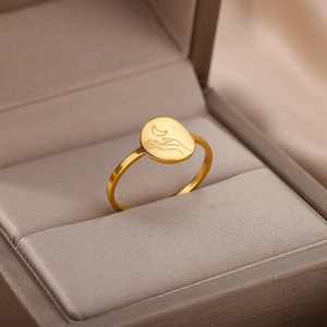 Detail of 18K gold stainless steel signet ring with moon and hand engraving in jewelry box