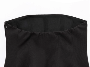 Detail of black tube top featuring multi-panel tailoring and invisible side zipper closure