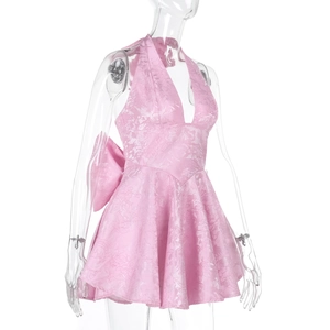 Detail of the pink jacquard halter dress showing the large back bow and fabric texture