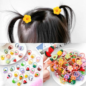 Colorful cartoon kids hair ties featuring fruits and animals in a multi-angle collage view
