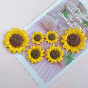 Detailed view of six resin sunflower DIY accessories in three assorted sizes