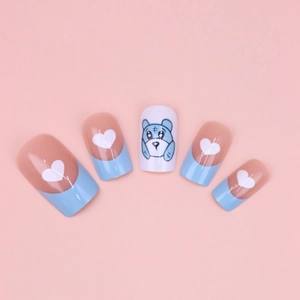 Blue French tips press-on nails featuring white hearts and cute cartoon bear patterns