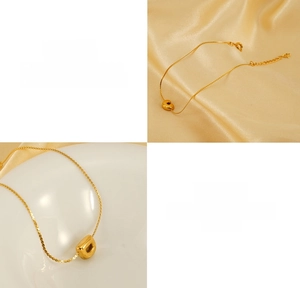Detail of 18K gold plated bubble letter charms on adjustable stainless steel bracelet