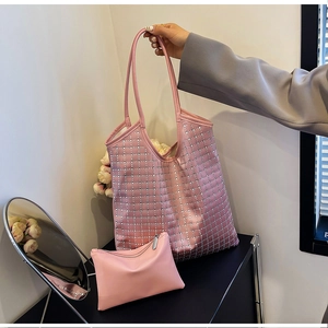 Pink rhinestone tote bag with matching pouch shown in a hand-held lifestyle setting