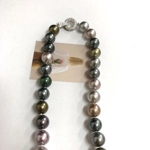 Macro shot of colorful Tahitian style pearls with a shimmering silver rhinestone clasp