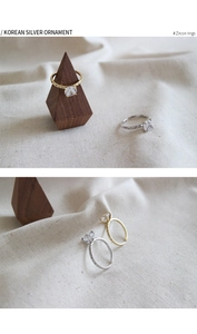 Close-up of elegant S925 silver rings with large zircons on rustic fabric and wood
