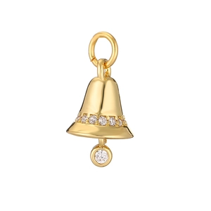 Macro detail of a golden Christmas bell pendant with sparkling crystals on white background