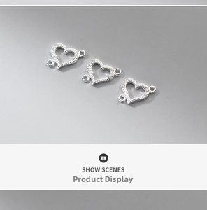 Detailed view of three silver heart-shaped connectors with pavé zircon for DIY jewelry