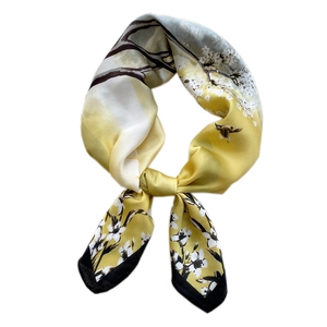 Silk-like bright yellow scarf featuring elegant white flower and bird patterns