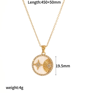 Detail view of a gold round sun and moon pendant with shell base and crystal pavé ring