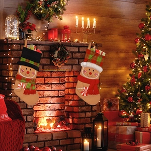 Detail of gingerbread man Christmas stockings hanging on a festive decorated fireplace