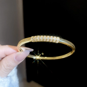 Detailed close-up of 18k gold plated bangle with pave-set sparkling zircon crystals