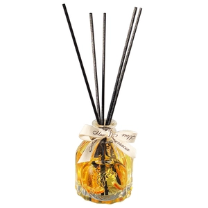 Rose citrus reed diffuser set with yellow glass bottle and black reeds on white background